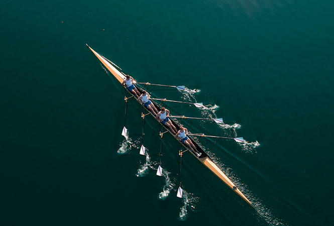 Rowing team on lake