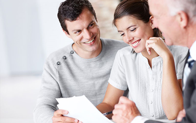 Young couple reviewing documents with advisor