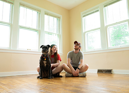 Couple sitting on floor with dog
